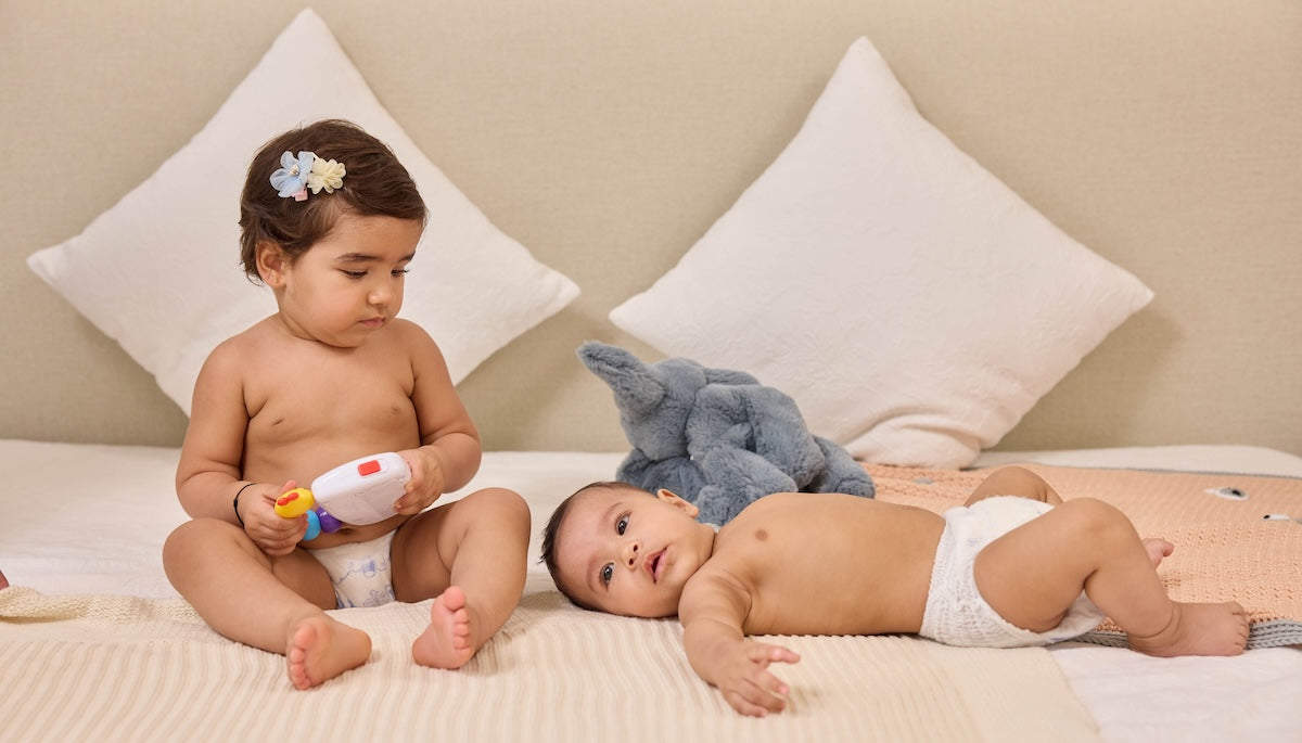 Two Babies in Pokito Baby Diaper Pants playing on the Bed - Pokito Baby