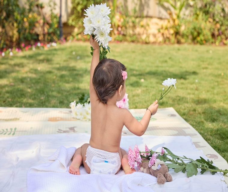 Baby in Pokito Diaper in the Garden